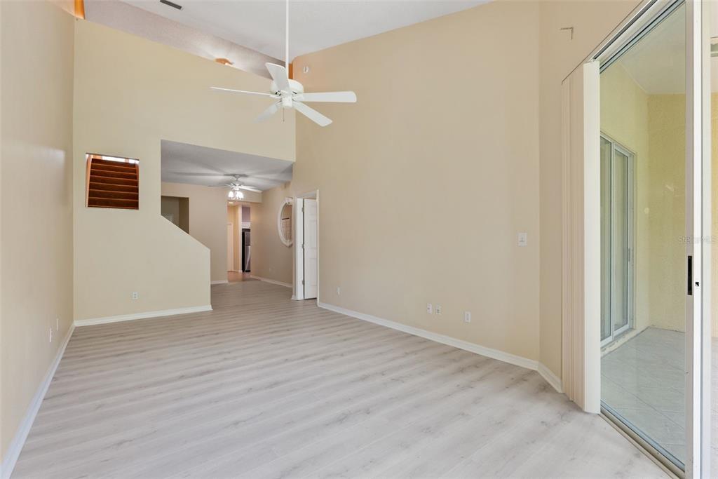 1050 Starkey Road, Unit 704 Largo, FL 33771 - Photo 8 of 27 a view of a livingroom with a dinning area wooden floor and a ceiling fan