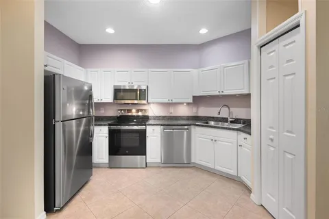 a kitchen with stainless steel appliances granite countertop a stove and a refrigerator
