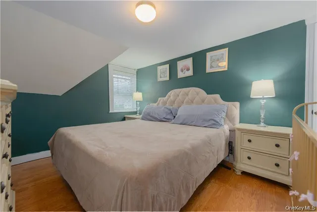a large bed sitting in a bedroom next to a lamp