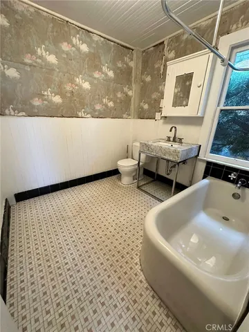 a bathroom with a bathtub and mirror