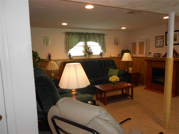 12 Kalmia Road Holbrook, MA 02343 - Photo 15 of 17 a living room with furniture and a fireplace