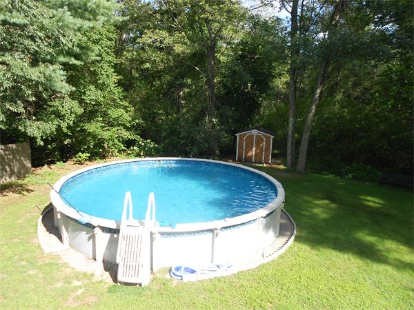 12 Kalmia Road Holbrook, MA 02343 - Photo 4 of 17 a view of a swimming pool with a yard and large trees