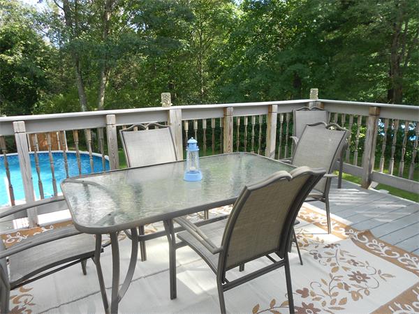 12 Kalmia Road Holbrook, MA 02343 - Photo 5 of 17 a view of a chairs and table on the deck