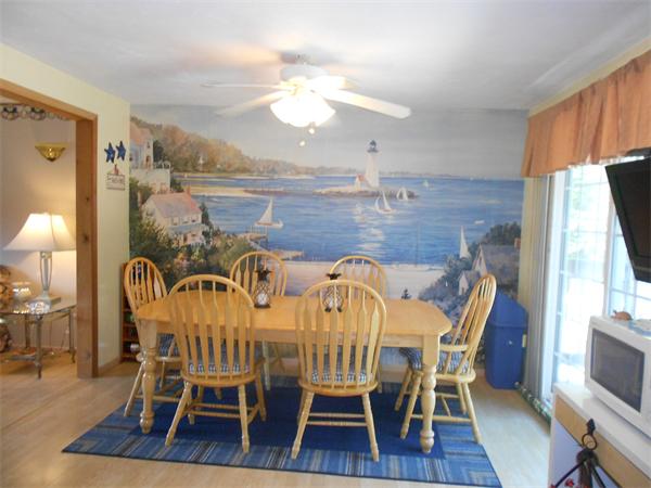 12 Kalmia Road Holbrook, MA 02343 - Photo 9 of 17 a dining room with furniture a chandelier and wooden floor
