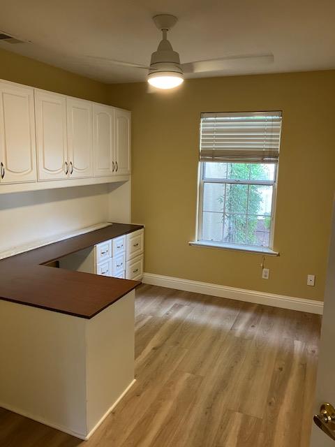 2157 West Rue St Michel Fresno, CA 93711 - Photo 3 of 22 a view of an empty room with wooden floor and a window