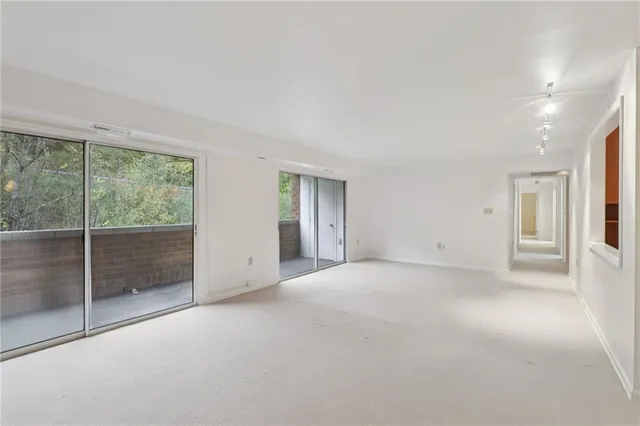 an empty room with a empty space and windows