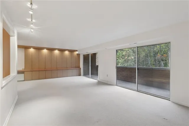 a kitchen with stainless steel appliances granite countertop a refrigerator a stove and a sink with wooden floor