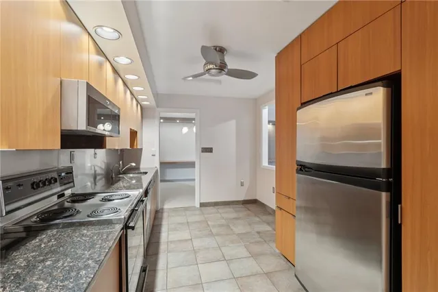 a kitchen with stainless steel appliances granite countertop a stove and a microwave