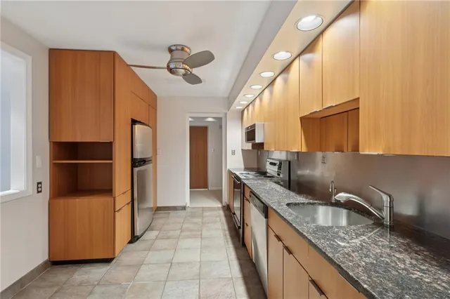 a kitchen with stainless steel appliances granite countertop a refrigerator and a sink