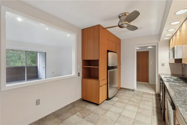 a utility room with cabinets washer and dryer