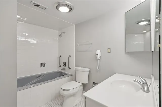 a bathroom with a sink a toilet and a mirror