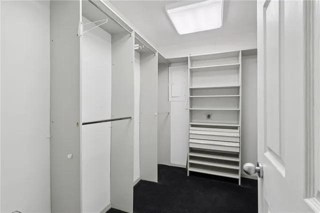 a spacious bedroom with a bed and a cabinets