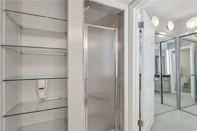a bathroom with a double vanity sink mirror and shower