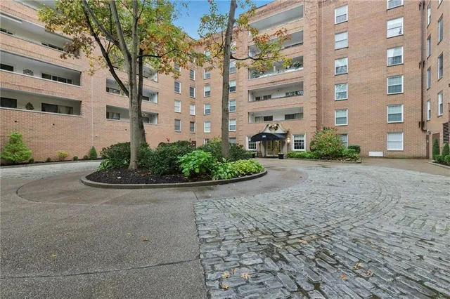 a view of a brick building next to a road