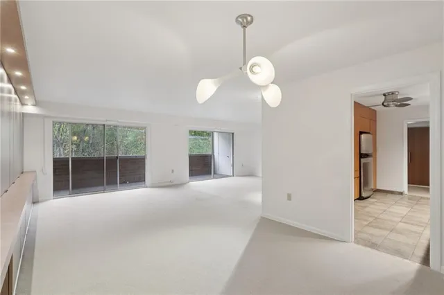 a view of a livingroom with a chandelier fan
