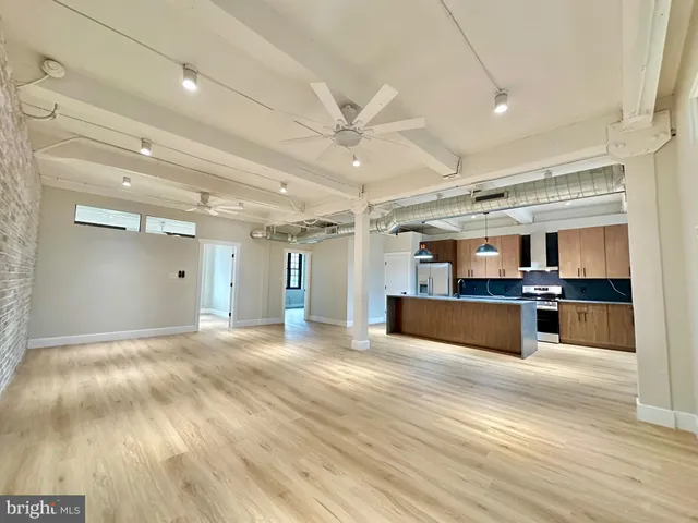 a view of a kitchen with a sink and a refrigerator