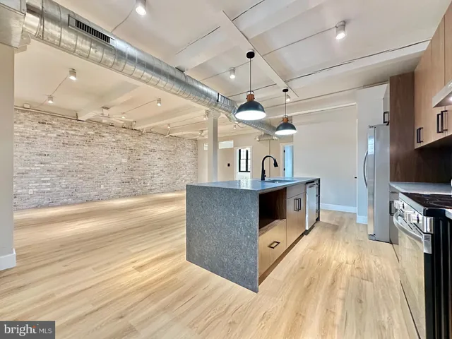 a view of a living room kitchen and a wooden floor