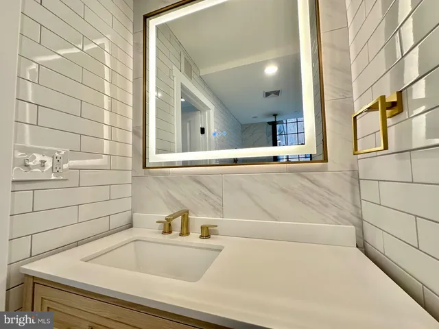 a bathroom with a bathtub and sink