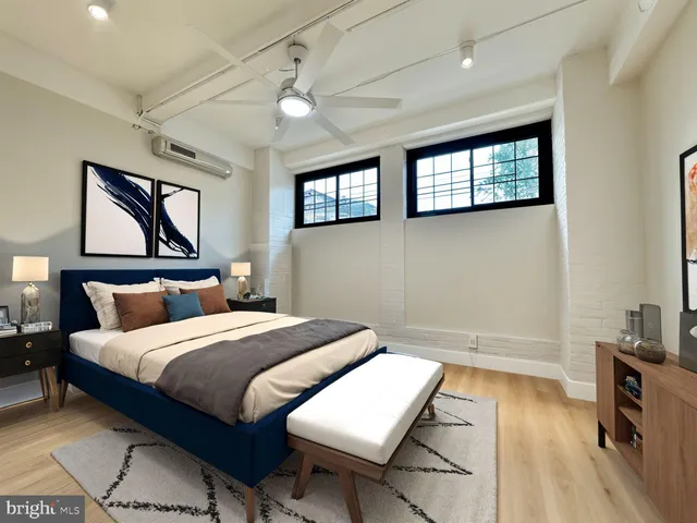 a bedroom with a bed and a lamp on table