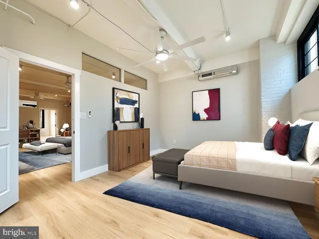 a bedroom with a bed and glass door