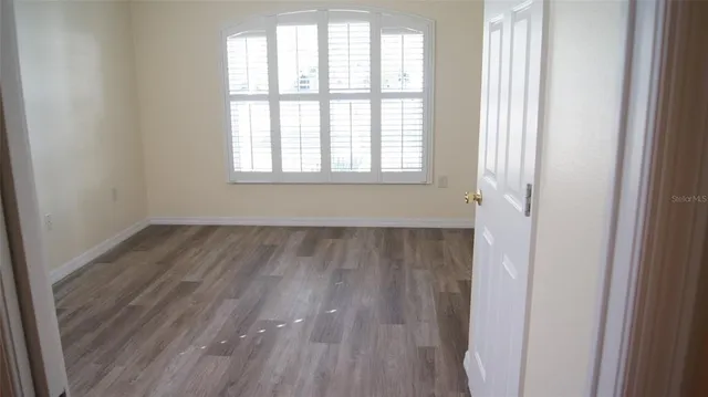 a view of a room with wooden floor and windows