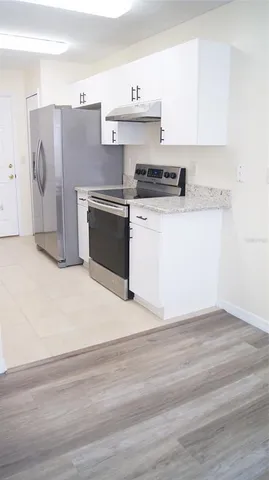 a kitchen with cabinets and stainless steel appliances