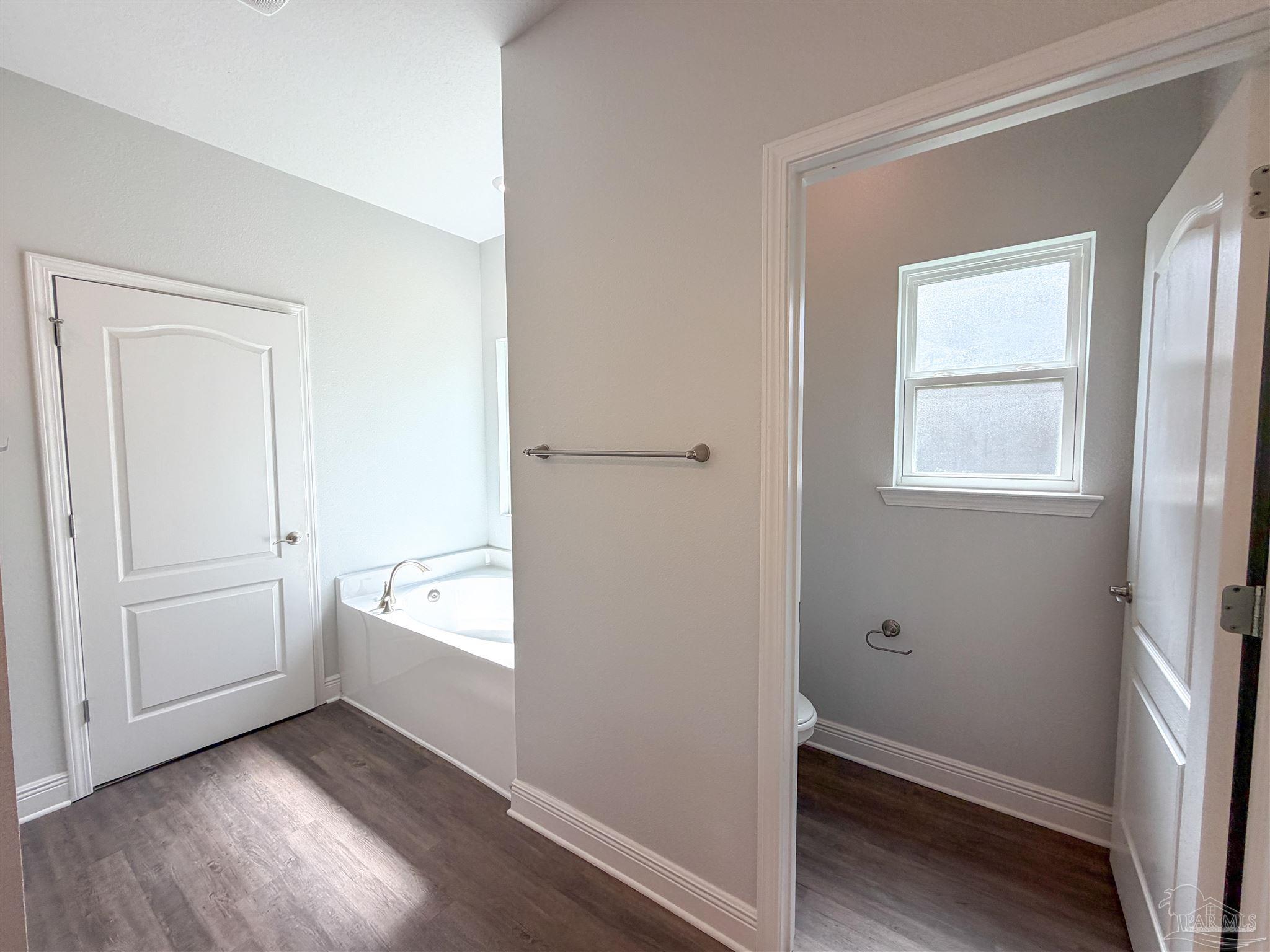 3613 Conley Drive Cantonment, FL 32533 - Photo 13 of 32 a view of an empty room with wooden floor and a window
