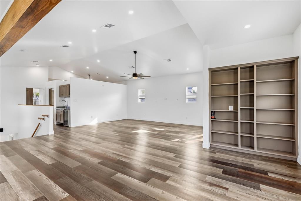 4436 Thunder Road Dallas, TX 75244 - Photo 11 of 33 Wood-finish flooring, built-in shelving, vaulted ceilings, recessed lighting, and a ceiling fan