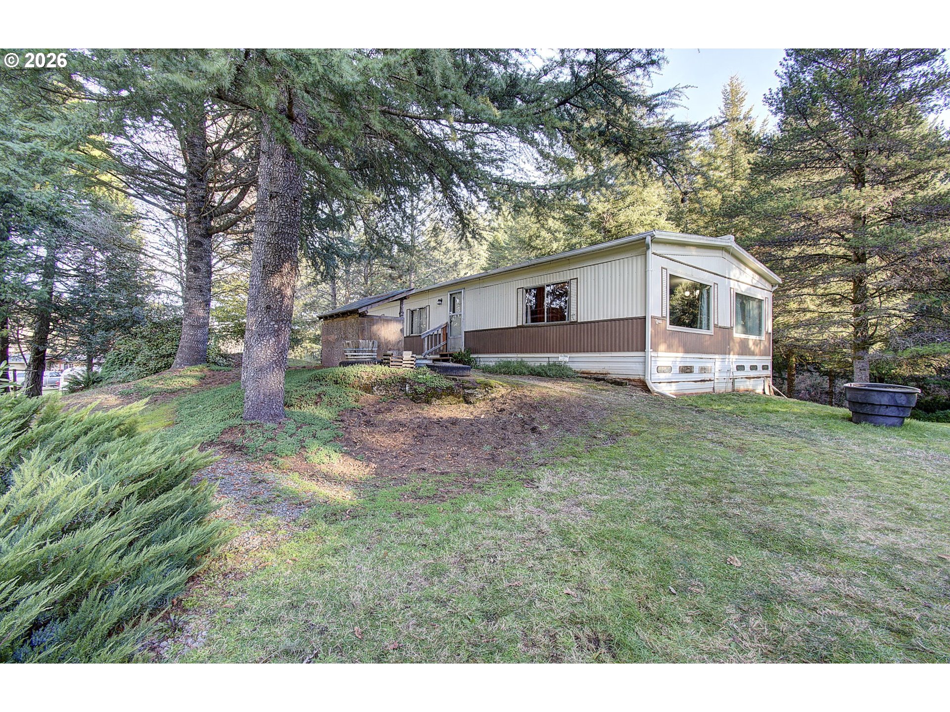 a view of a yard in front of a house with large trees