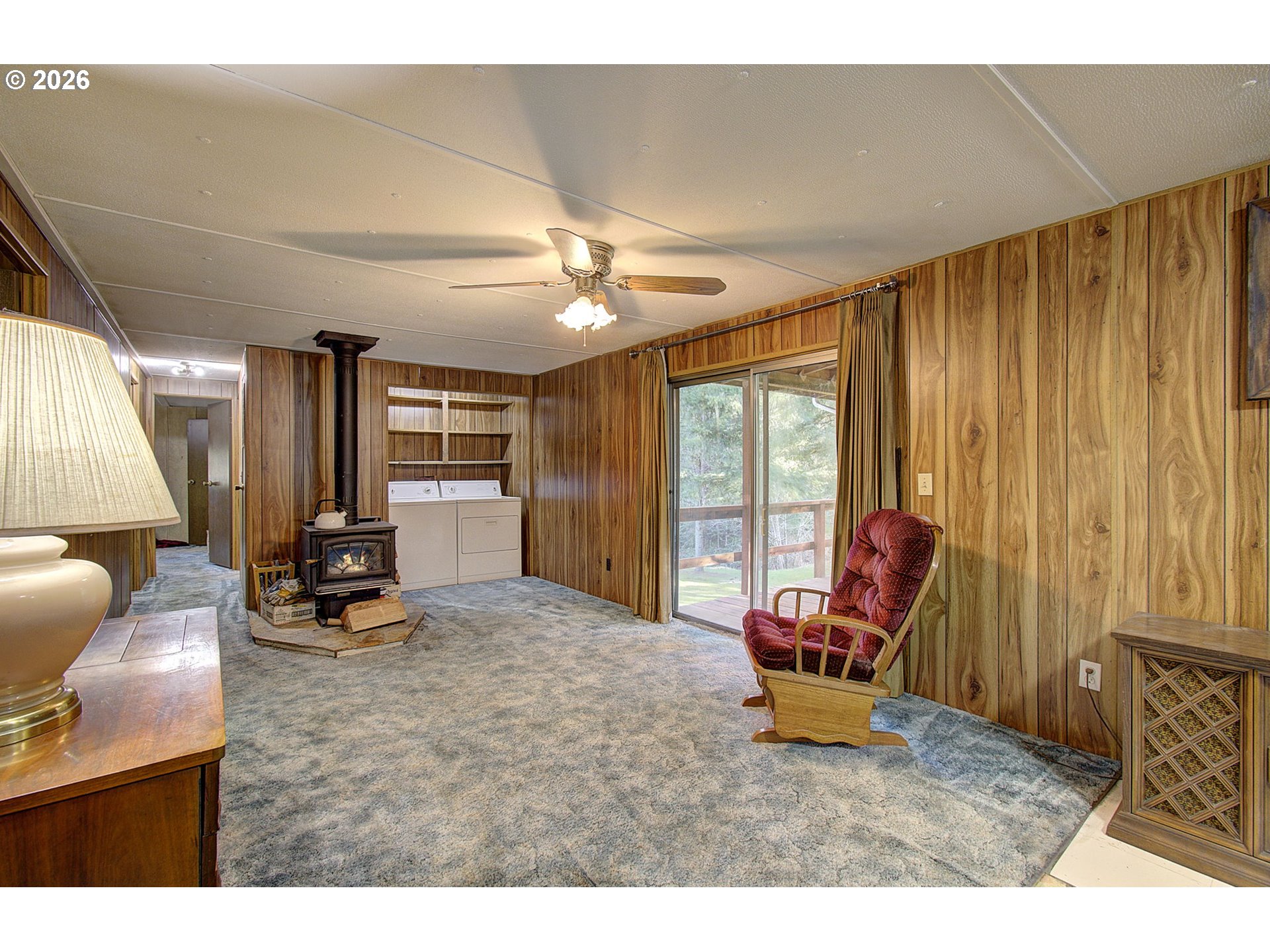 41615 Northeast Cedar Ridge Road Amboy, WA 98601 - Photo 4 of 44 a living room with furniture a large window and gym equipment
