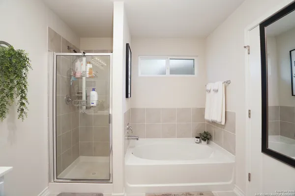 a bathroom with a bathtub and a shower