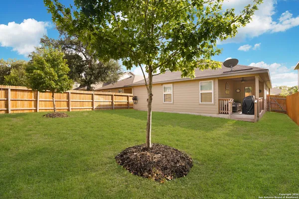a backyard of a house with table and chairs