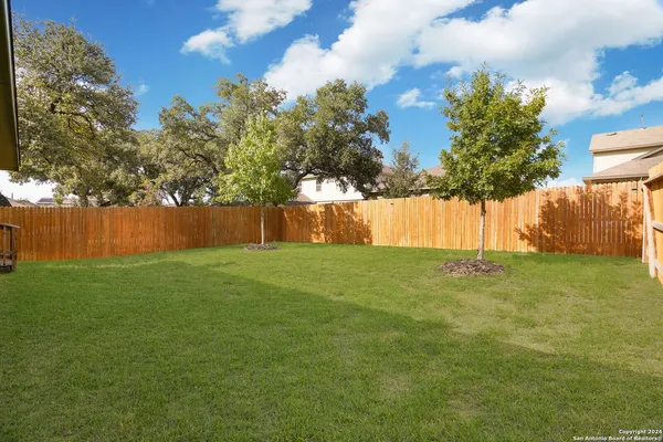 a view of yard with swimming pool and green space