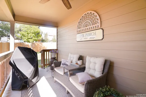 a view of a hallway with couch and a window