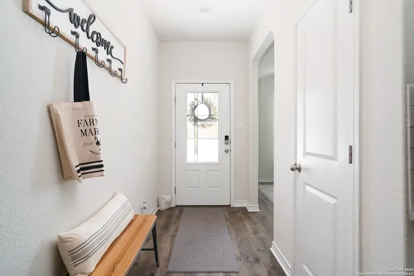 a view of a hallway with windows and stairs