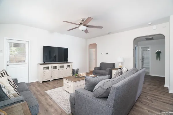 a living room with furniture and a flat screen tv