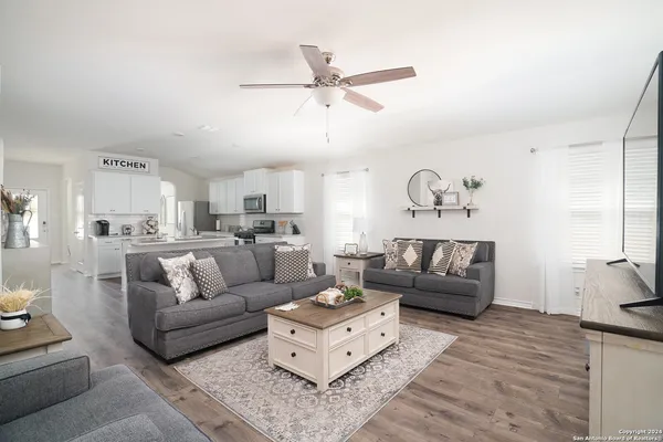 a living room with furniture and a chandelier