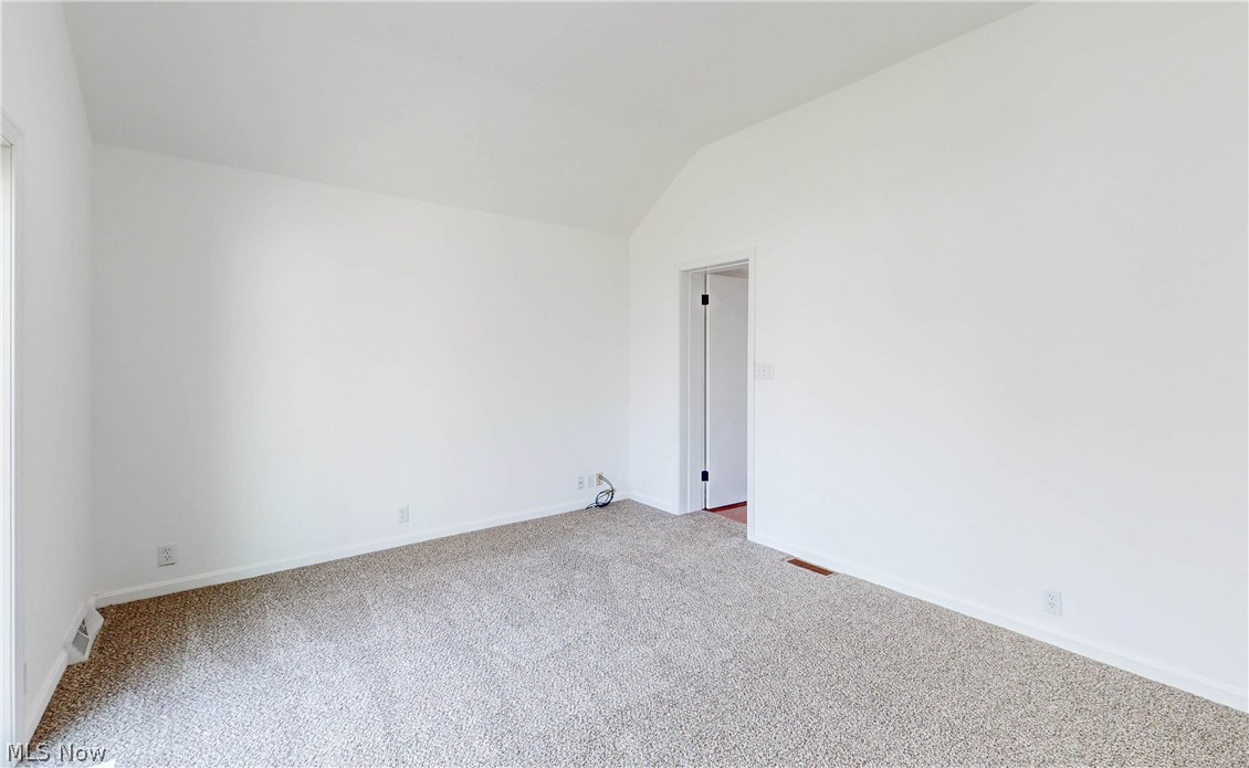 1844 Oakmount Road Cleveland, OH 44121 - Photo 16 of 26 Carpeted empty room with lofted ceiling