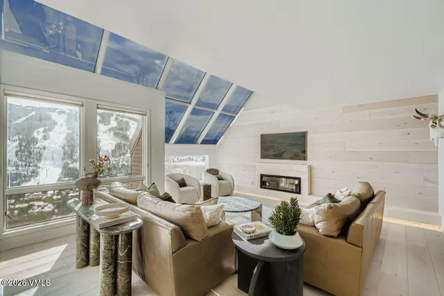 a living room with furniture and a floor to ceiling window