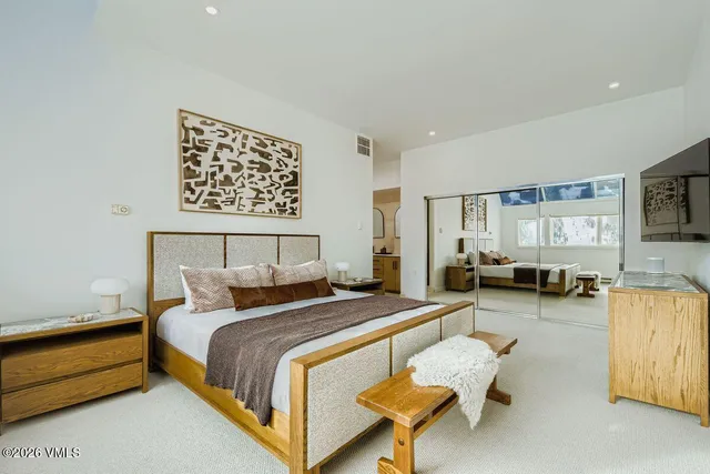 a bedroom with bed and a couch