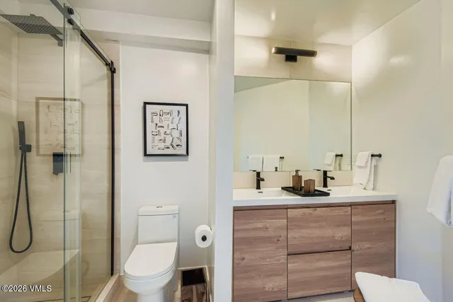 a bathroom with a toilet sink and shower