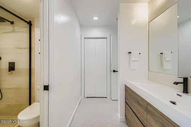 a bathroom with a tub sink toilet and mirror