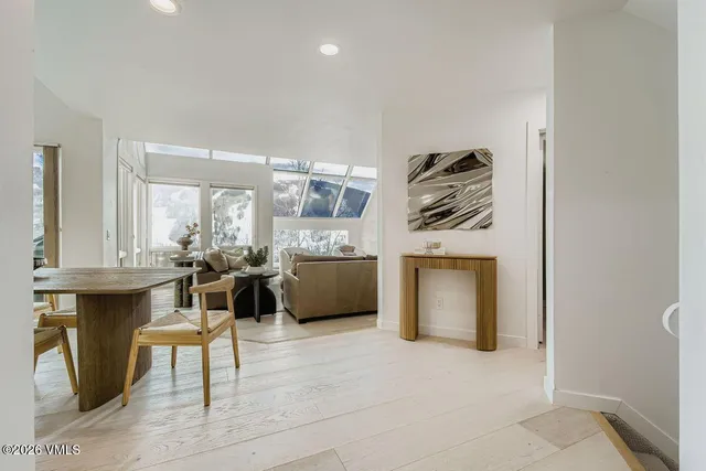a living room with furniture a fireplace and a kitchen view