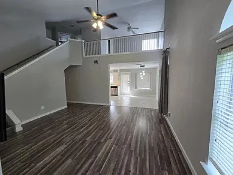 wooden floor in an empty room with a window