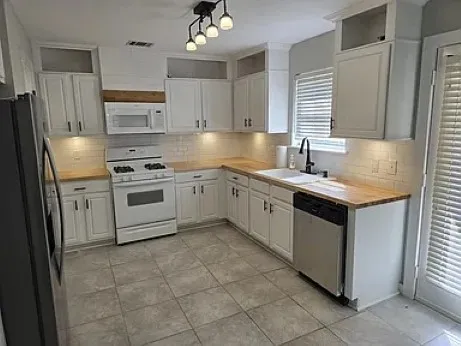 a kitchen with a stove sink and refrigerator