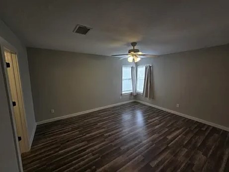 811 Chiselpoint Cove Round Rock, TX 78681 - Photo 6 of 13 a view of an empty room with wooden floor and a window