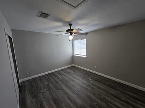 811 Chiselpoint Cove Round Rock, TX 78681 - Photo 10 of 13 an empty room with a ceiling fan and window