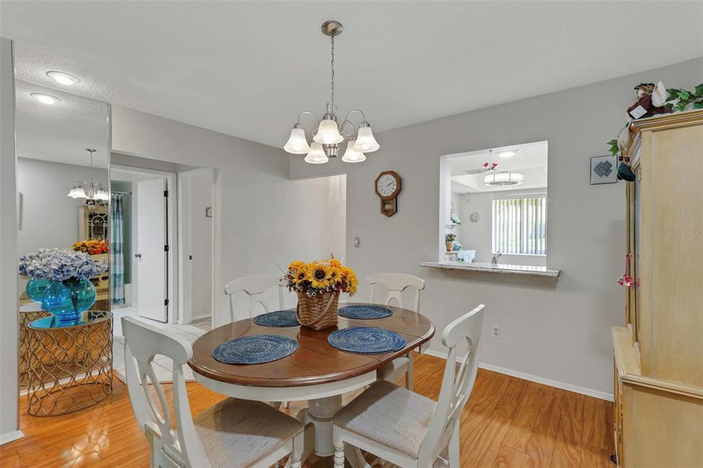 1011 Dunrobin Drive, Unit B Palm Harbor, FL 34684 - Photo 17 of 37 a dining room with a table and chairs