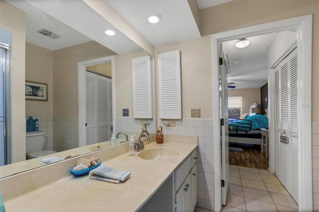 1011 Dunrobin Drive, Unit B Palm Harbor, FL 34684 - Photo 20 of 37 a bathroom with a granite countertop sink and a mirror