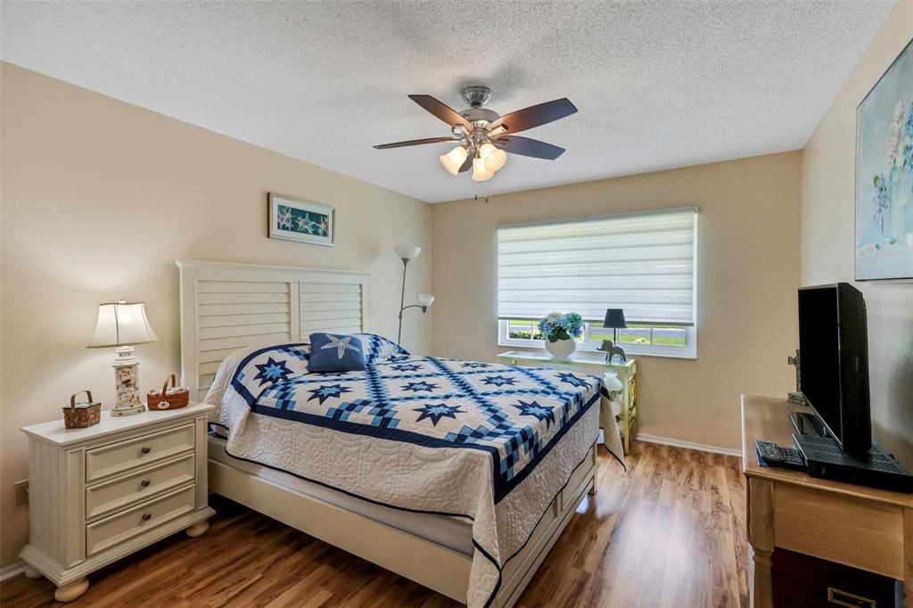 1011 Dunrobin Drive, Unit B Palm Harbor, FL 34684 - Photo 22 of 37 a bed room with furniture and a flat screen tv